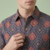 Men’s indigo geometric printed cotton shirt close-up with classic spread collar and button detail